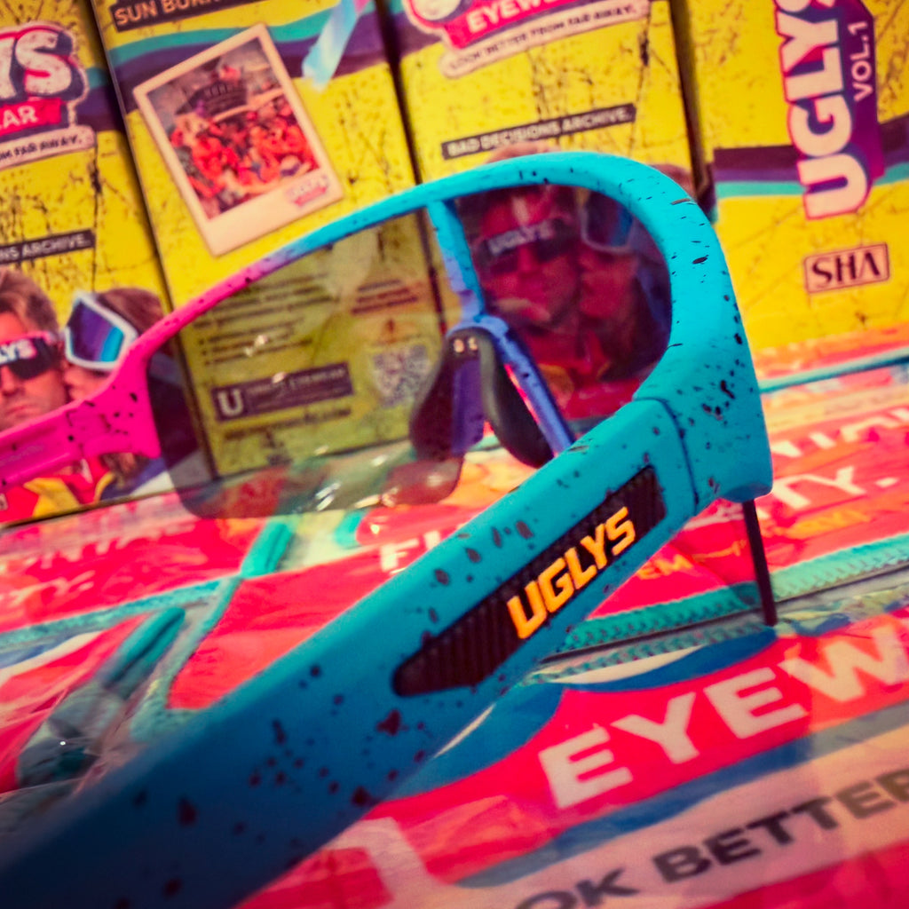 UGLYS™ Neon Violation sunglasses from UGLYS EYEWEAR with bright neon-colored frames and dark tinted lenses.