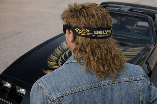 UGLYS Gold Wing sunglass strap attached to stylish sunglasses, featuring a sleek gold wing design for eyewear security.